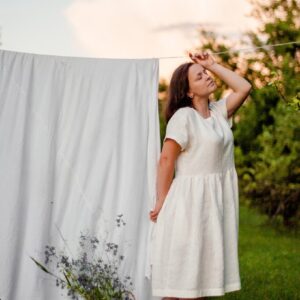 woman in white dress standing on green grass field